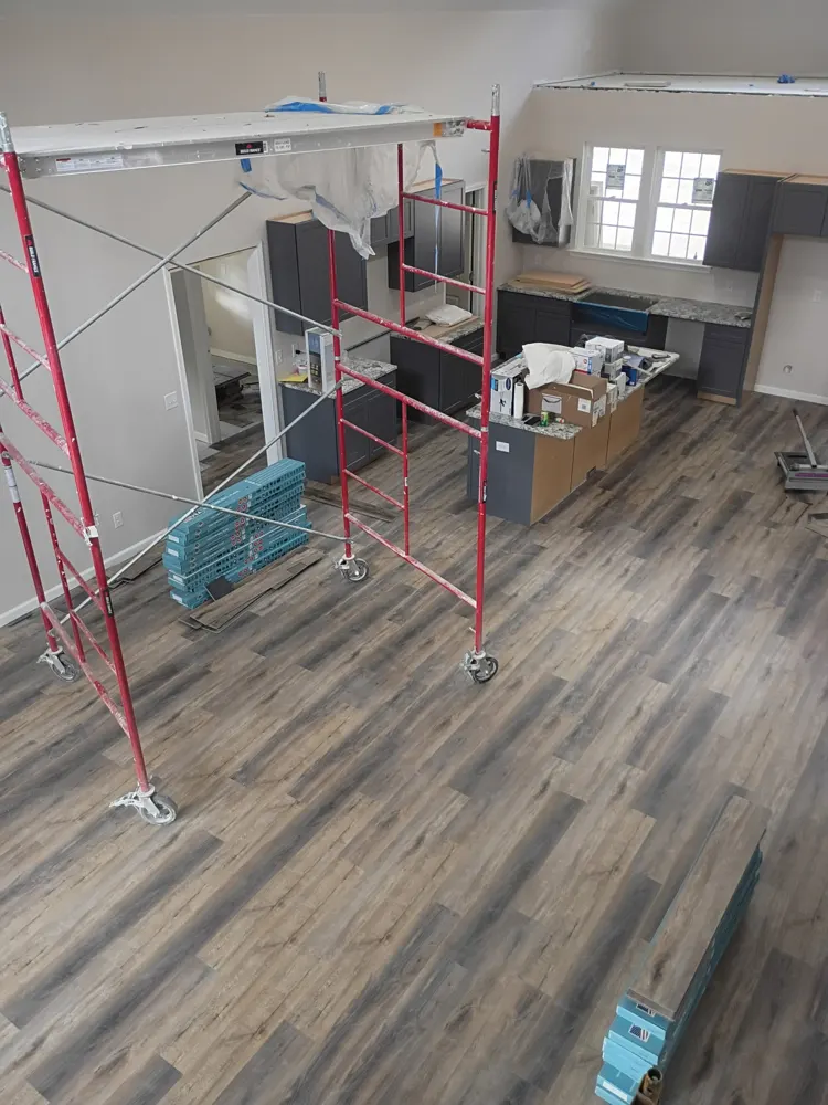 Luxury vinyl plank flooring installed in an open kitchen and great room of a new home under construction in Honey Ridge Estates, Guyton GA
