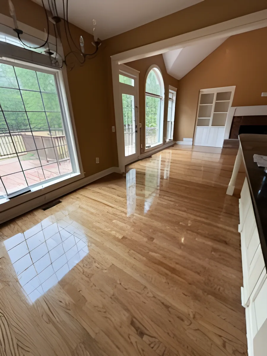 Refinished hardwood floor in open dining and living area