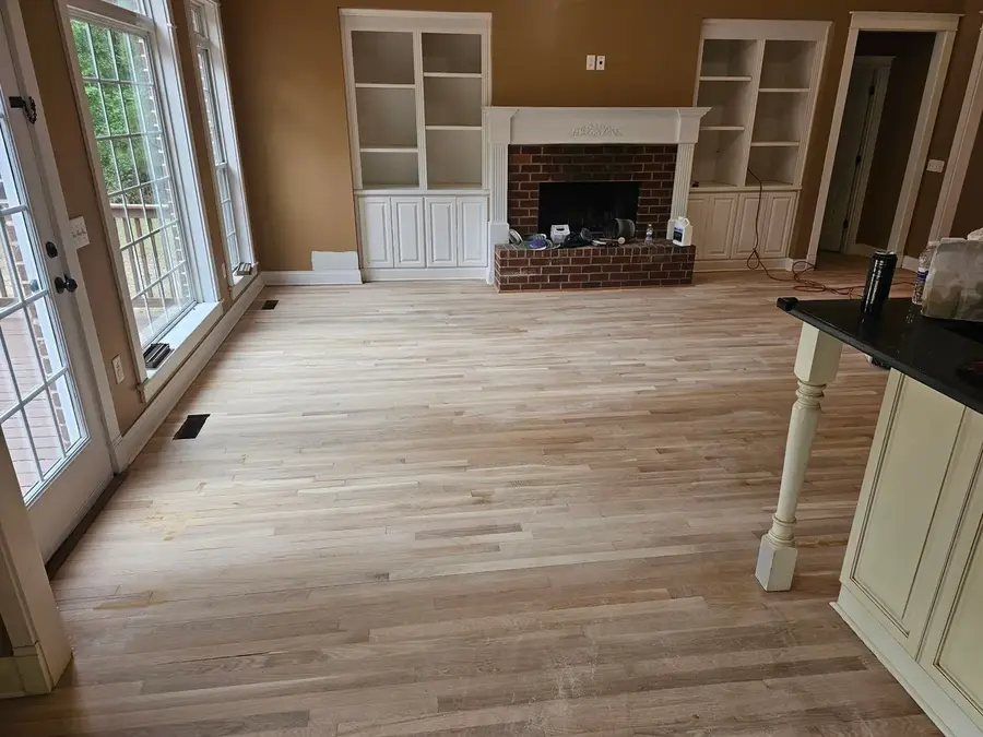 Hardwood floor sanded down to bare wood during refinishing