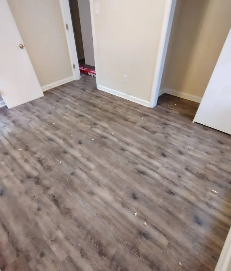 Gray luxury vinyl plank flooring in a bedroom in Buckhead, Richmond Hill GA