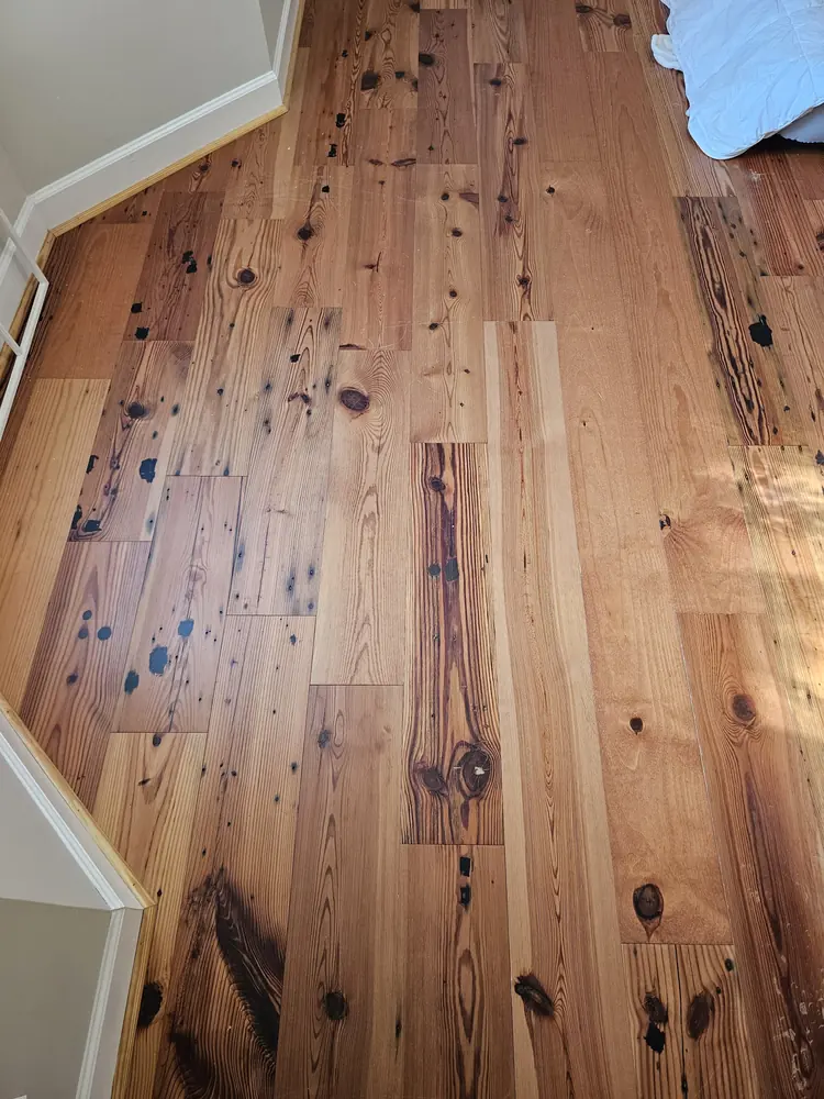 Knotty engineered wood flooring along a stair landing in Silverwood Plantation, Rincon GA
