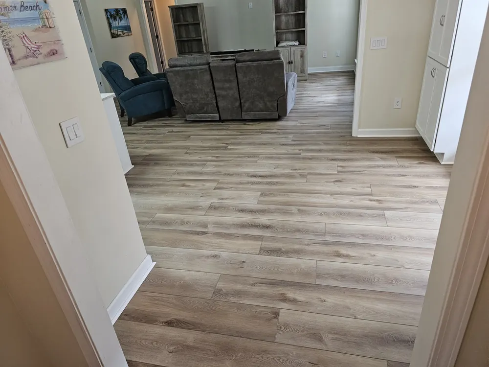 Luxury vinyl plank flooring through a hallway and living area in Lost Plantation, Rincon GA