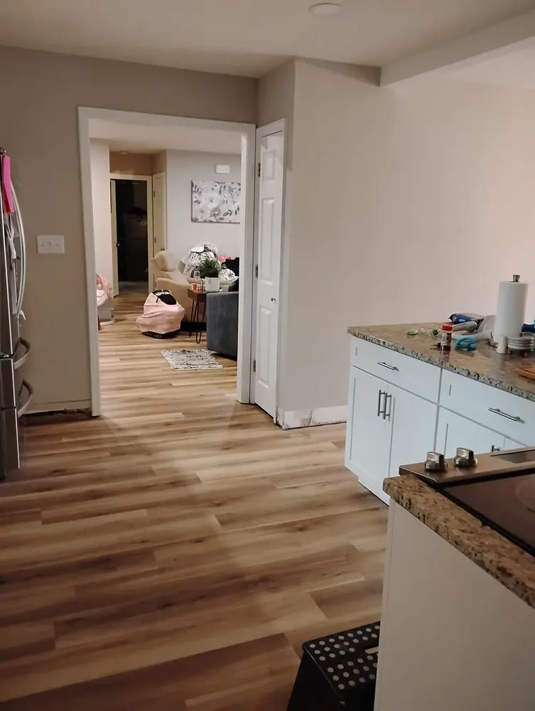 Luxury vinyl plank flooring flowing from kitchen to living room in Westwood Heights, Rincon GA