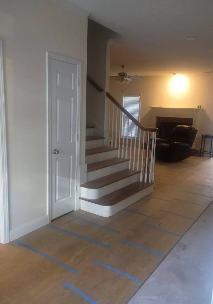 Engineered wood flooring being installed in a front entry by the staircase in Irongate, Statesboro GA