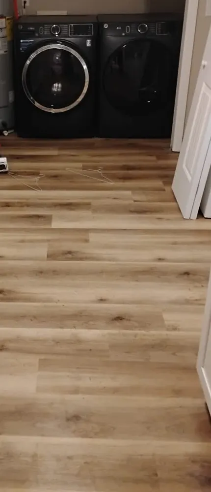 Wide-plank luxury vinyl plank flooring in a laundry room in Georgian Walk, Statesboro GA